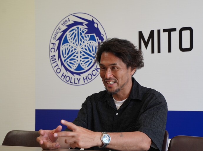 写真：インタビューを受ける本間さん