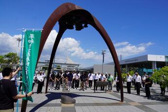 平和の鐘の前で黙とうを行う様子